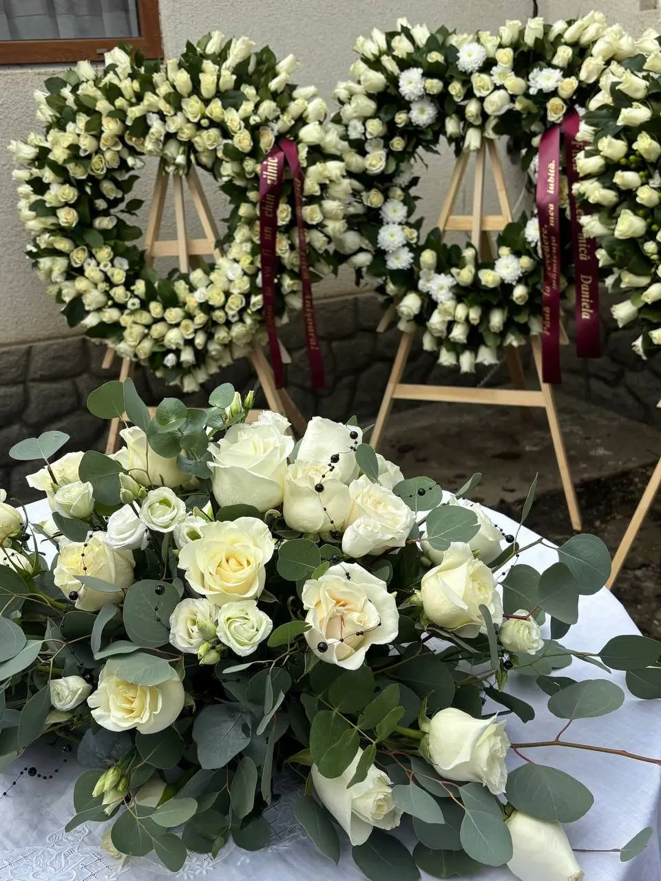 Two heart wreaths of white roses and a table arrangement