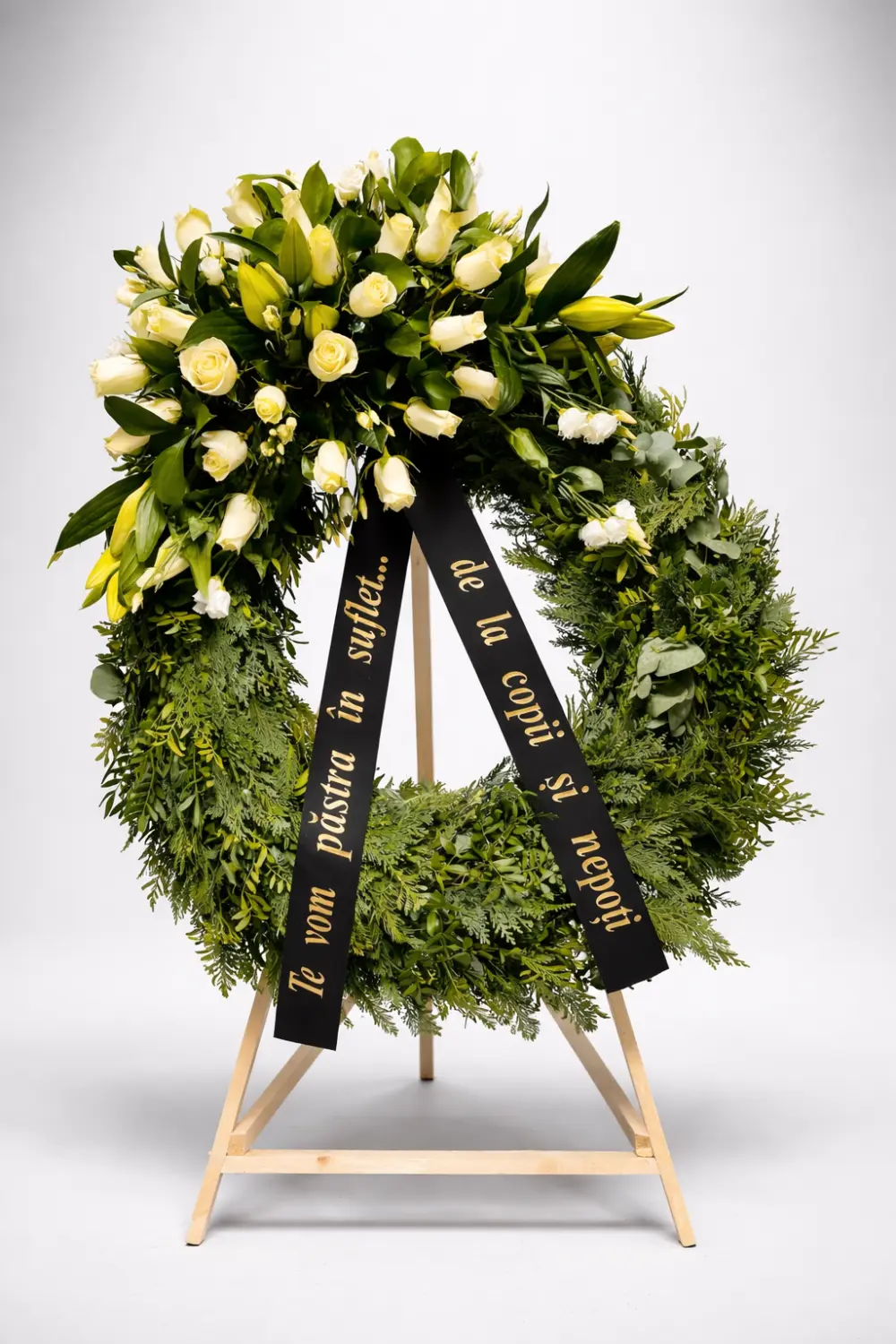 Round wreath of cream roses and lilies with thuja
